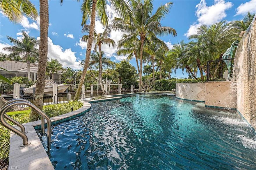 Ideally located in prestigious Aqualane Shores yet steps to the beach and 3rd St S. Dock your boat at the private boat dock with 16,000 lb. lift capacity. Boasting the coveted Southern exposure for all day sun on the pool and boat dock. Special highlights of the home include four en-suite bedrooms, gracious gourmet kitchen with Wolf gas range, Sub-Zero refrigerator, gas instant hot water throughout, large and inviting living room ideal for entertaining, with an enchanting gas fireplace in the living room, Acacia hardwood floors, cathedral ceilings, and all overlooking pool and water views. The master suite is enriched with two walk-in closets and a luxurious spa bath. Enjoy your formal dining room to entertain a multitude of guests. Home was built in 2012 with Hurricane Impact Windows and Doors and hurricane shutters were added on the patio. Sprawling entertaining spaces flow outside to the generously sized patio area that can be enjoyed year-round. Easy and direct access to the Gulf of Mexico. Located in an ideal location close to Gordon Drive, and just minutes to the beach.