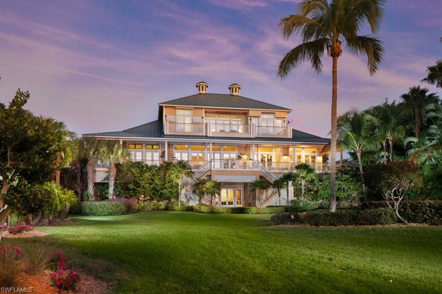 This stunning beach house is being offered at an exceptional price. You will be wowed by the ocean views, easy beach access and the charming wraparound veranda that is accessed by French doors from every room. Perfect for hosting family and friends, this three-level home with elevator boasts nearly 6,500 square feet of main living space with a total of over 17,000 square feet and is situated on a direct, Gulf-facing double lot. Enjoy six bedrooms, six-and-a-half baths, gourmet eat-in kitchen with adjoining outdoor grill area, open great room and dining room with soaring ceilings, library and separate study, three laundry rooms, ground-level family room with kitchen,  four-car garage, workshop, backup generator and more. Includes 25-foot boat dock with lift. The ultimate beach and boating lifestyle property.