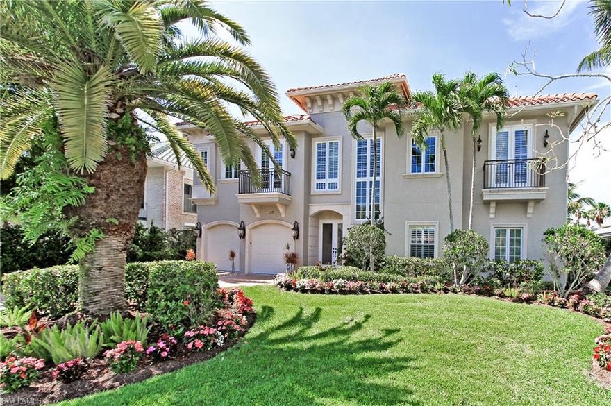 LOCATION...LOCATION...Located on one of the only 3 streets off of Gulf Shore Dr. within walking distance to one of the best rated beaches in the country...Vanderbilt Beach!!!  This upscale, updated, exquisite home offers coffered, detailed ceilings, marble flooring, crown molding, a gourmet kitchen with white cabinetry, island,  beautiful stonework, marbles, and granite, Windows in front of home are PGT and are replaced with impact glass. Baths also have been updated with the beautiful stonework, marbles, and granite. This spacious floorplan allows for optimum use with a large family room with balcony, 3 bedrooms-(2 master suites) and den on the main level and a wonderful in-law/guest suite at the lower level with its own kitchen, full bath, and bedroom.  Wonderful pool/spa oasis surrounded by tropical trees, water views, and dolphins playing in the canal.  AND IF THIS ISN'T ENOUGH...a very rare find...grandfathered in, tiled covered (matches house roof) boat dock recently rebuilt (2014) with lift and platform, to take you away to the warm Gulf waters!  This home must be seen to be appreciated.  A pleasure to show your clients!