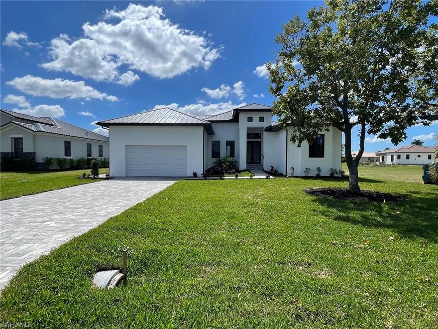 This BRAND NEW 4 bedroom/3 bath custom-built home, located within the Burnt Store Lakes development (a subdivision of Punta Gorda Isles) is nearly complete and ready for you. The home's open floor plan is refreshingly unique and features any number of designer-inspired touches including exquisite tile flooring throughout, recessed lighting as well as contemporary lighting fixtures, ceiling fans and beautiful tray ceilings highlighting select rooms. The kitchen is graced with a substantial island, a stainless-steel appliance package and quartz counter-tops as well as ample cabinet and counter space. The spacious living/dining area adjoins the kitchen and provides access to the primary lanai (under truss) through an impressive three panel sliding glass door. The lanai, complete with a metal railing, can also be accessed through the dining area as well as one of the other bedrooms. The fourth bedroom could also be used as an office or media room - an option so many homes lack today. The master bedroom features a tray ceiling, large closet and an over-the-top ensuite with a fully tiled shower and a dual vanity. Additionally, the master's private lanai (complete with a metal railing) is accessed through a 2-panel slider and overlooks the backyard providing an ideal spot to just sit back and relax. The guest bathrooms feature double sinks while one has a tub/shower combo and the other a fully tiled shower. The handy laundry room has washer/dryer hookups and provides additional storage as does the attached 2-car garage. The home has a sturdy metal roof, impact resistant windows and doors for added storm protection. Exterior features include an impressive, covered entryway, a paver-laid driveway and walkway and an automatic sprinkler system. The home is on both water and sewer. NOTE: Some of the photos in this listing have been digitally enhanced so as to provide a more accurate depiction of the home when completed. **This is a Bank Owned Property**