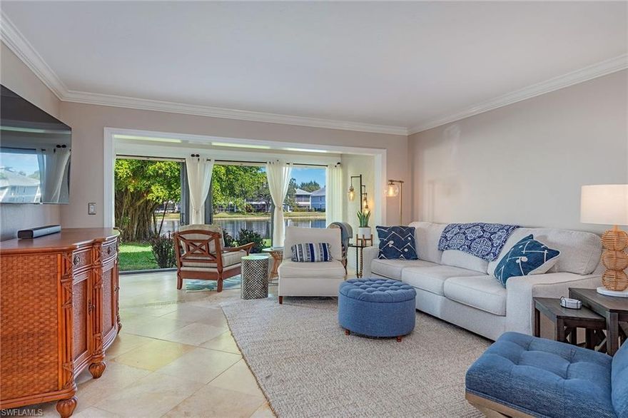 Experience relaxed coastal living in this updated Pinewoods condominium in the heart of North Naples. Offering approximately 1,472 square feet, this two-bedroom, two-bath residence blends modern comfort with timeless appeal. The bright kitchen features a breakfast nook, generous pantry and dining area with a built-in bar. Enjoy marble flooring throughout, newer appliances and a new roof replaced about three years ago. The spacious living area opens to a glass-enclosed lanai overlooking a tranquil lake, ideal for morning coffee or evening sunsets. The primary suite includes a walk-in closet and lanai access, while the guest suite provides a separate retreat. Pinewoods residents enjoy two pools, a spa, and tennis and pickleball courts in a low-density, serene community. Ideal as a full-time residence or seasonal retreat, this home also offers strong rental potential. Minutes from beaches, fine dining and shopping, it captures the best of North Naples living.