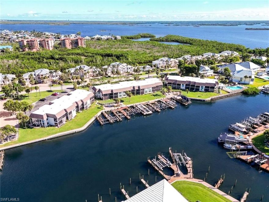 This highly desired, renovated two-bedroom, 2-bath totally renovated condo at Estero Island Yacht & Racquet Club offers a highly desirable WEEKLY RENTAL policy and a prime location just one block from the Gulf beaches. This first-floor residence provides direct views of the canal and green space, where you can watch passing boats and dolphins, and simply enjoy the coastal lifestyle. Recent upgrades include new tile and carpet flooring throughout, fresh paint, new bathroom vanities and showers, new kitchen counters and cabinets, newer appliances and hurricane-impact doors and windows. Additionally, it features a new hot water heater and air conditioner installed in 2024. The lanai and master bedroom have electric hurricane shutters as well as hurricane windows and sliders throughout. Estero Island Yacht & Racquet Club is a pet-friendly community with low fees, lush landscaping, and potential dock purchase opportunities. Close to shopping, dining, and island amenities, this property is ideal as a vacation home or investment due to year-round rental demand. Your coastal retreat awaits!!