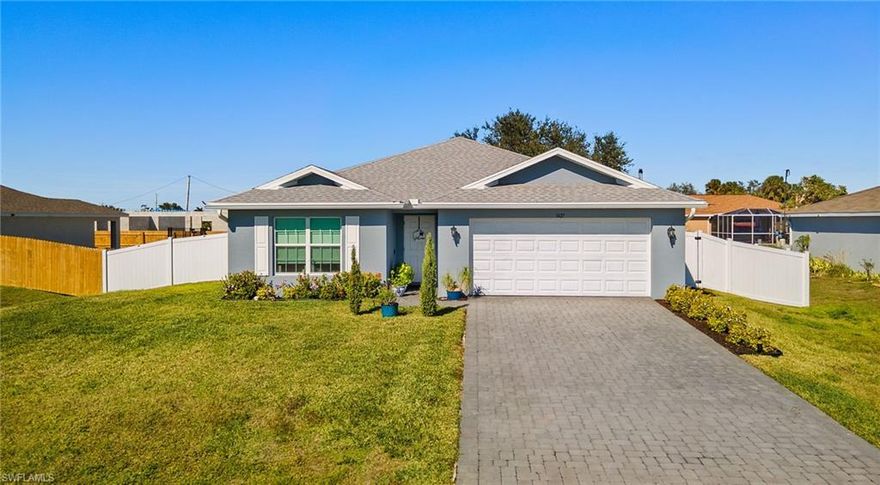 BETTER THAN NEW –  This Captivating home is packed with upgrades, it also offers a Structural Warranty till 2031. This is one of the lowest-priced newer construction homes in the area. Built in 2021 by Christopher Alan Homes, and located in the faster growing area of  NE Cape Coral, just a minute from Del Prado Blvd N. This house offers a tile floor throughout, a private backyard with a white vinyl fence, beautiful, low-maintenance landscaping, a screened, covered Lanai—ideal for relaxing or hosting, and a water softener system with an additional carbon water filter. Enjoy the open floor plan with vaulted ceilings, a spacious living room, a modern kitchen with a central island, and a walk-in pantry. The kitchen flows seamlessly into a light-filled dining room with a stylish tray ceiling. The primary suite offers a generous walk-in closet and an en-suite with dual sinks, a walk-in shower, and plenty of linen storage. Additional features include an oversized paver driveway, a double car garage, a complete set of stainless steel appliances, a separate laundry room with a full-size washer and dryer, Beautiful Zebra blinds in main areas, and blackout blinds in all bedrooms, ceiling fans in all rooms, and other features.  This location is 3 minutes away from Publix supermarket, shops, and restaurants, 5 minutes away to 41 (Tamiami Trail), and 15 minutes away from Downtown Fort Myers,  Save over $23K in upgrades. There are NO HOA fees and you have the freedom to rent at any time of the year.