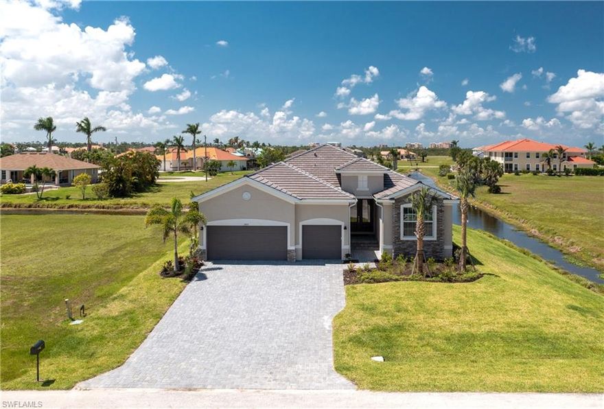 If you're searching for brand new construction without the wait, look no further! This sought-after Summerville II plan boasts custom finishes and a desirable waterfront location. Step inside and be greeted by luxury vinyl plank flooring throughout . The layout connects the living room, dining area, and kitchen, forming a versatile space ideal entertaining. Your eyes will be drawn to the dramatic custom stone accent wall, with a built-in electric fireplace flanked by bench seating. Featuring stainless steel appliances and a sprawling center island, that offers ample space for meal preparation and casual dining. The primary suite is complete with water views and an en-suite bathroom featuring dual split vanities, private water closet, and a roomy tiled shower. The two additional bedrooms, including one with an ensuite bath, will make friends feel at home while they visit. Step outside onto the covered lanai and discover a tranquil oasis, where you will enjoy observing Florida wildlife in the pond. Extend the lanai or add a new pool to expand the possibilities for outdoor recreation and relaxation. The three car garage with epoxy flooring is the ideal space to store all your toys!