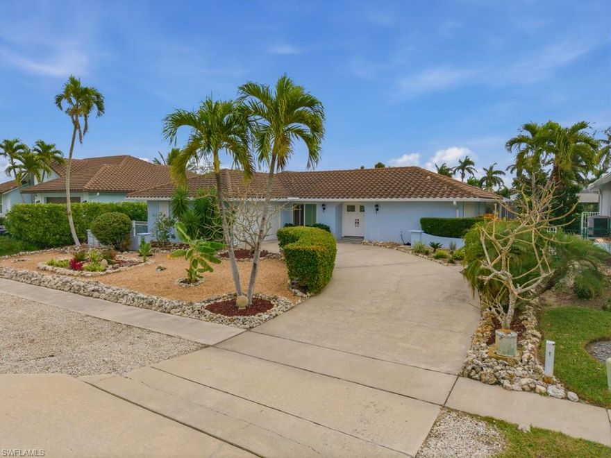 Best value for a waterfront home on Marco Island with all day sunshine on the pool! As an added plus, just completed was a brand new 80' seawall! Popular southeastern exposure makes this 3-bedroom, 2-bath home bright and cheerful. Plus, there are plantation shutters, tile plank and carpet flooring, and a welcoming newer double-door entry. The kitchen has white cabinets, granite countertops, stainless steel appliances, a new microwave, a new range and a pantry. The primary suite has a slider for outdoor access, while two guest bedrooms on the other side of the home share a full bath. Enjoy outdoor living on the screened lanai (2019) overlooking the retiled and resurfaced pool (2017). Additional upgrades include new HVAC (2023), water heater (2023), roof (2017), new Square D electrical box (2025) & garage door (2018). You'll save $ on your water bill with the low-maintenance grass-free yard that is a tropical retreat with a mature avocado tree, flowering plumeria and other plants that don't require irrigation. The yard beyond the pool is ready for your favorite landscaping or paver deck. This home has hurricane shutters for your peace of mind and there is a sidewalk along the right side of the home.