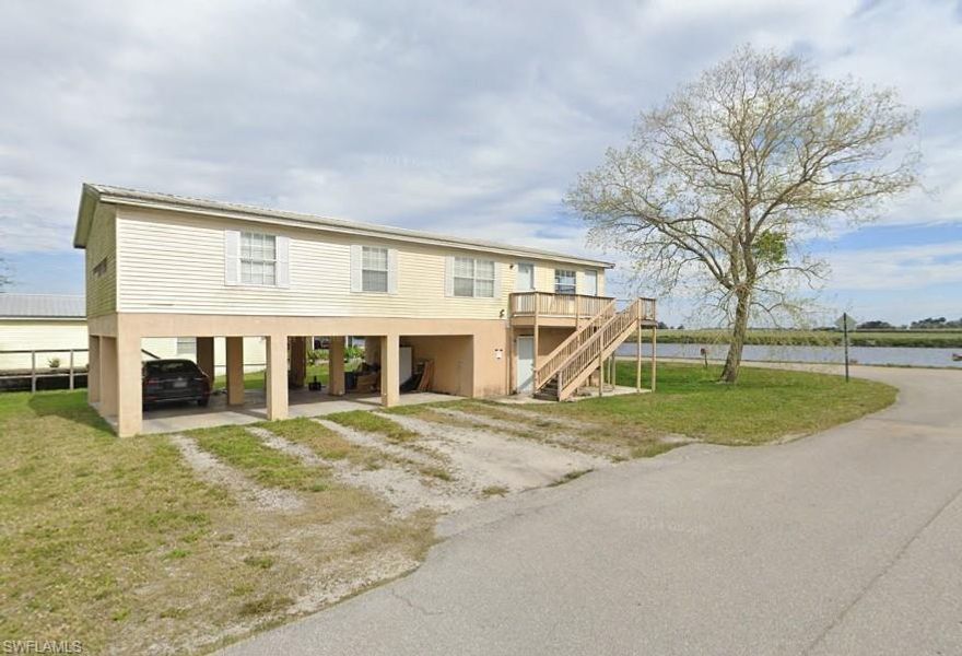 Enjoy stunning waterfront views from this elevated 3-bedroom, 2-bathroom home located in the heart of Moore Haven. The upstairs unit features brand new carpet, natural lighting, and spacious bedrooms. Downstairs offers three carport spaces and a separate studio unit, freshly painted with newly laid floors including its own bathroom and den area—ideal for guests, in-laws, or a private home office. Picnic by the water or dock your boat just down the road—this listing offers it all! Whether you're looking for a weekend retreat, investment opportunity, or full-time residence, this unique riverfront gem has endless potential!