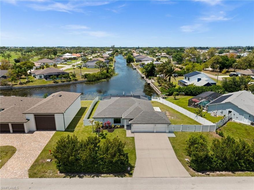 LONG WESTERN CANAL VIEWS on an INTERSECTING CANAL! 2020 BUILT HOME with CUSTOM, HEATED SALTWATER POOL, DOCK WITH BOAT LIFT, AIR-CONDITIONED 3-CAR GARAGE, and OVERSIZED LOT. Welcome to 1808 SW 8th Pl, a 4 BEDROOM, 2 bath waterfront home BUILT IN 2020 offering 1,718 sq ft of living space on a beautiful INTERSECTING FRESHWATER CANAL with spectacular long water views. Situated on an oversized lot of more than a quarter acre, this property offers an uncommon amount of outdoor space along with privacy created by a fully FENCED YARD and lush landscaping in front. WESTERN EXPOSURE provides incredible sunset views down the canal every evening.

The outdoor living area is designed to take full advantage of the waterfront setting. The large SCREENED LANAI features a CUSTOM, HEATED SALTWATER POOL built in 2022 with a unique swim-up table, integrated umbrella stand, water features and tanning shelf, all overlooking the water views. The pool system is SMARTPHONE APP CONTROLLED, allowing you to easily manage heating, lighting, and pool features from anywhere. Just beyond the pool, the property includes a 40’ x 20’ DOCK WITH BOAT LIFT installed in 2022, offering excellent freshwater fishing for Peacock and Largemouth bass or easy access for kayaking and cruising the canal system.

Inside, the home features tile flooring throughout, high ceilings, and an open split-bedroom floor plan. The kitchen offers granite countertops, stainless steel appliances, an island with breakfast bar, and a great view down the canal. The adjacent dining area includes sliding glass doors that open directly to the lanai and pool area, making indoor-outdoor living easy.

The spacious primary suite enjoys water views and direct lanai access through sliding glass doors, along with two walk-in closets and an en-suite bath with dual sinks and a tiled shower. On the opposite side of the home, the 3 ADDITIONAL GUEST BEDROOMS are arranged for privacy, with 2 ADJOINING ROOMS that work well for guests or families. The guest bathroom also functions as a convenient POOL BATH.

Additional features include a 3 CAR GARAGE WITH MINI-SPLIT A/C (2021), laundry room with washer and dryer, and a large FENCED SIDE YARD that provides excellent space for storage, equipment, or additional outdoor use. The home also includes SMART HOME FEATURES, with app-controlled pool equipment, smart door locks, and smart lighting that allow convenient control and monitoring from your phone. The pool and lanai were added in 2022, the dock and lift in 2022, and the fence in 2021.

Located in the heart of SW Cape Coral, this home offers easy access to shopping, dining, schools, and parks while enjoying one of the best long canal views in the area. The property is NOT IN A FLOOD ZONE AND HAS NOT FLOODED IN ANY HURRICANE.