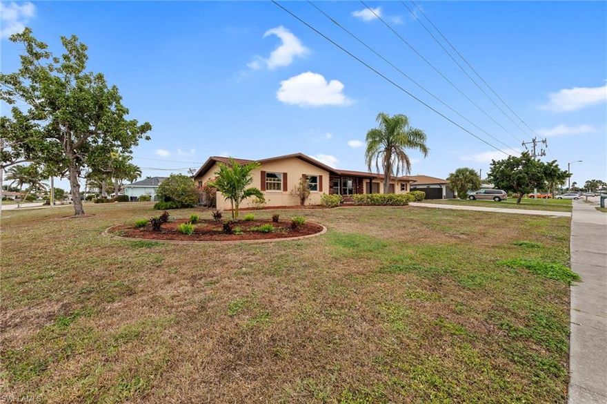 This inviting ranch-style pool home features three bedrooms and two bathrooms and is situated on a rare oversized, corner triple-lot. The expansive lot not only enhances privacy and curb appeal but also offers ample space for gardening, entertaining, or future additions—providing unmatched flexibility for your lifestyle. Positioned at the end of the canal, the elevated lot ensures there have been no water-related concerns, giving peace of mind to homeowners. Inside, you'll find engineered wood flooring throughout the main living areas, with cozy carpeting in each bedroom. The spacious fenced yard is perfect for outdoor activities, while the expanded storage shed and three-car garage, complete with a workshop area, offer plenty of room for hobbies and projects. Outdoor amenities include a screened pool enclosure with a built-in bar and a covered lanai—ideal for enjoying Florida’s beautiful weather. All city assessments have been paid in full, saving you money and providing added value and convenience. Imagine relaxing by your screened pool with friends on warm evenings or hosting family gatherings in your spacious backyard oasis. With some cosmetic updates and your personal touch, this home could truly shine and become your ideal retreat.