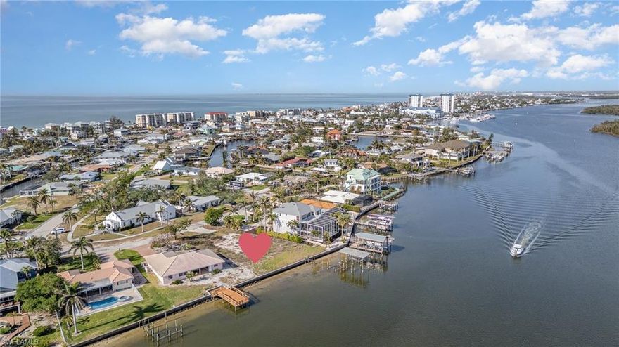 STUNNING & EXPANSIVE unobstructed BAY & WATERFRONT VIEWS across Estero Bay Aquatic Preserve from this OVERSIZED cleared and buildable BAY FRONT lot! Over 100' of spectacular water frontage on over 1/3 of an acre which wakes up to beautiful sunrises across the bay and is only a short distance to Deeded Beach Access &  sunsets on the Gulf! ONE OF THE MOST SOUGHT-AFTER WATERFRONT AND BOATING COMMUNITIES ON THE ISLAND, Holiday Heights, is KNOWN FOR ITS HIGHER ELEVATION AND GULF-ACCESS CANALS and warm & friendly community. Build your custom designed dream home on this oversized bay front lot offering awe inspiring views and the best in coastal living! Located mid-island close to Publix grocery store, trolley stop, full service marina, Fresh Catch Exquisite Waterfront Dining & Junkanoo Below Deck for the more casual waterfront dining experience. Don't miss out on this opportunity to own one of the few vacant bay front lots in this desirable mid island neighborhood location!