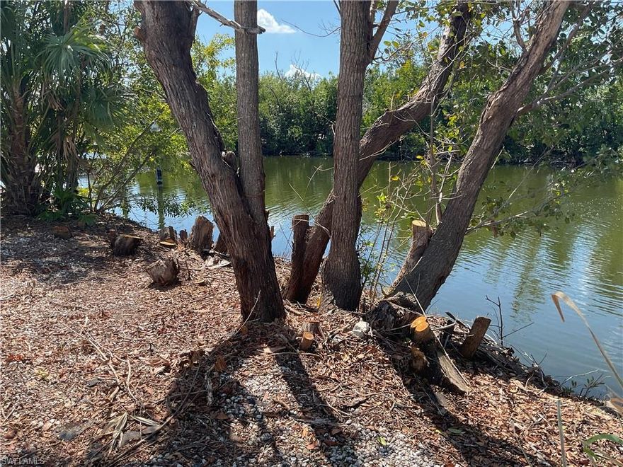 GULF ACCESS LOT ---Located in beautiful Pine Island Cove 55+ community. This lot is cleared, has water, electric & sewer ready to hook up to your new home. There are no impact fees to be paid unless you Build a stilt home or have a new site built home then you have to pay the difference. This lot is located in the back of the community on the water and there is no homes behind the lot.  This community has heated saltwater pool, spa, picnic area, dog park, RV and boat storage, private boat ramp that is just a few minutes out to some of the best fishing in SW Florida or you can visit the outer islands like Cabbage Key, Sanibel, or Cayo Costa beach. This community is located close to restaurant's, markets, banks and parks.