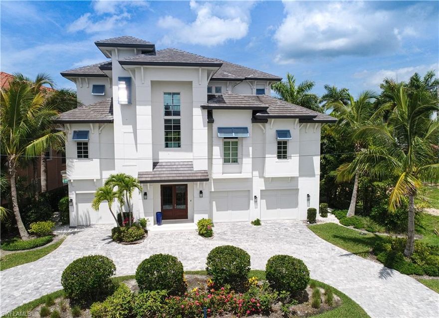 This beautiful luxury Bonita Beach custom home in the Carolands offers it all - long bay front views, western exposure offers stunning sunsets, premier boating to the Gulf of Mexico in 10 minutes, a short walk to the beach access, an elegant coastal design and furnishings are included. Open floor plan captures expansive bay views from nearly every room including large great room, kitchen and dining room that leads to a large covered lanai with electric screens and shutters all overlooking the pool and bay. Features include 5 bed 7 total baths, wide plank oak flooring, extensive mill work. custom built cabinetry, quartz countertops, thermador appliances, outdoor fireplace & TV, grille & Kitchen, 24K whole house generator and a private elevator. Rare first floor living level master suite with direct bay views.  The guest areas are well appointed with multiple true VIP suites including one that is a true second master suite plus a large upstairs recreation room with large lanai and best of the views!. Built by HR Stanley Custom Homes to hurricane codes.  Smart home technology with I pad controls. The pool/spa area is a tropical paradise and leads right out to the boat dock with lift.