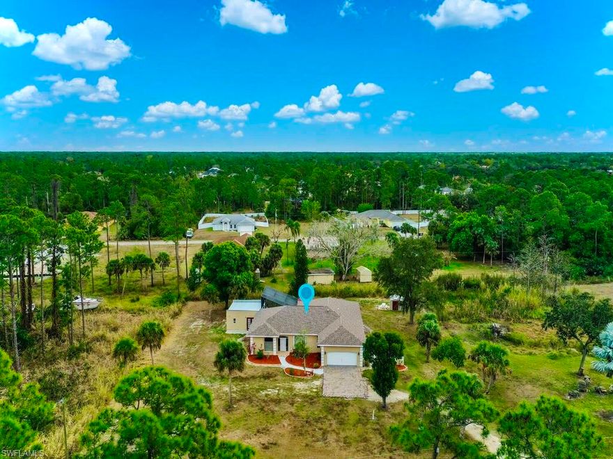 welcome to this MAGNIFICENT 4 bed 4 bath + Den POOL home with a detached in-law suite nestled away on a 1.5 ACRES PROPERTY! This peaceful property features GRAND elevations with HIGH ceilings & custom FLOATING soffits and has been freshly painted & spotlights a (2025) DIMENSIONAL shingle roof,  HIGH-END granite countertops with an astounding breakfast bar & TOP-TIER glass display cabinetry, recessed & pendant lighting, newer STAINLESS STEEL appliances, new LUXURY vinyl flooring, and an unique VAULTED caged over the illuminated pool with plant shelf including a SPIRAL staircase up to a SUN DECK, outdoor kitchen, & nicely tiled back patio with a swing GREAT for entertaining. This enormous floor plan highlights appealing glass FRENCH doors, A tank-less water heater, an amazing master suite with an admirable tiled walk-in multi JETTED shower, an awarding WALK-IN closet with organizers, dual stand alone vanities, and a desirable soaking tub.  It also features Accordion Hurricane shutters, new WATER softener system, premium fixtures, storage shed, outdoor shower, refreshing big bay windows, a screened tiled front porch, custom mirrors, window treatments, whole house fan, and Laundry under air with storage cabinets. This TRIPLE lot is NOT in a flood zone & just minutes to all major amenities & a quick commute to Fort Myers. Schedule your showing today!
