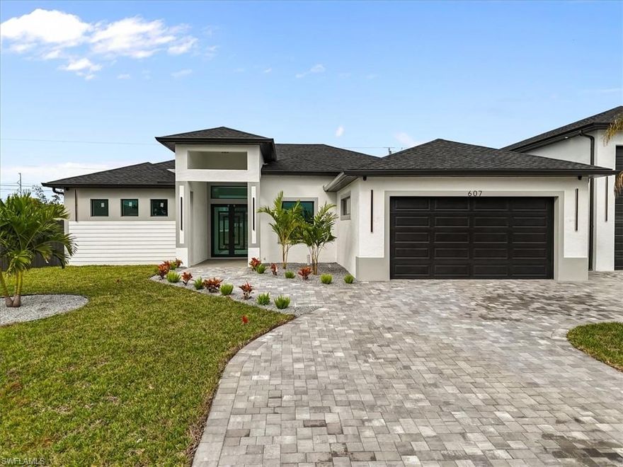 Luxury home on a 0.34 acre (15,000 sqft) lot in one of Cape Coral fastest growing areas. This 4 bedroom, 4 bathroom home offers a total of 4,034 sqft, with 2,484 sqft under air conditioned. It features 12-ft ceilings, an open-concept layout, spray foam insulation for maximum energy efficiency, and high end finishes throughout. The impact-resistant and tinted windows and doors provide safety, and peace of mind—plus, NO flood insurance required. Enjoy a 30x12 ft pool, a 250 sqft lanai, and a stylish outdoor kitchen. The 1,094 sqft garage with 16ft ceilings accommodates RVs or boats includes a 380 sqft guest suite with a full bathroom. Additionally, there is a second garage for two vehicles. The house is equipped with quality appliances, security cameras and Bluetooth speakers. Ideal for luxury living or investment, with potential for a private business or separate rental unit fully detached from the main home. Situated in a quiet community with strong investment potential. Ideal as a primary residence, long-term rental, or investment property. At the lowest price in the area schedule your private tour today—this home won’t last!