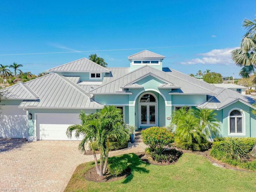 This stunning property offers the perfect blend of elegance, comfort, and breathtaking views and is ready for your boat. This direct access home boasts 4 BR/ 2 baths plus den, and a host of luxurious features. The open-concept living area is flooded with natural light, highlighting the high ceilings and modern finishes throughout. The gourmet kitchen is a chef's dream, equipped with top-of-the-line appliances,granite countertops, custom cabinets, & large center island. Unwind in the serene master suite, complete with dual sinks, granite countertops, dual head shower and spa-like bathtub. Step outside to discover an oasis in the oversized lanai w/ saltwater pool, spa & outdoor kitchen w/built-in gas grill, refrigerator, and ice maker perfect for entertaining guests. Large lighted Trex dock w/new 30,000 lb & 13,000 lb. dual boat lifts & 2,500 lb. dinghy davit. Indulge in the coastal lifestyle with nearby access to pristine beaches and outdoor activities. Don't miss this opportunity to own a piece of paradise.