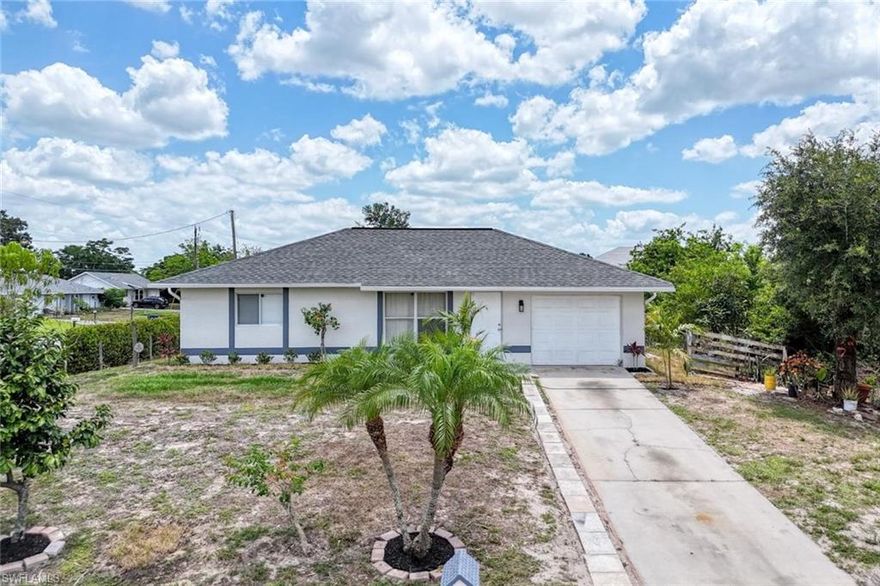 Discover comfort and convenience in this beautifully maintained 3 bedroom, ideally situated on an oversized corner lot adorned with mature citrus and mango trees. Nestled on a quiet dead-end road, this home offers peace and privacy while remaining just minutes from State Road 82, shopping, dining, and everyday essentials.
Step inside to an inviting open floor plan with recent updates including a newer A/C unit (4 years old), a newer roof (2 years old), all new outlets, and brand new lighting fixtures, providing a move-in ready experience. The home also features a well-maintained water system (approx. 7 years old).
Enjoy the relaxed Florida lifestyle in a home that offers both charm and convenience. Don’t miss this opportunity to own a slice of paradise in a growing area of Lehigh Acres!