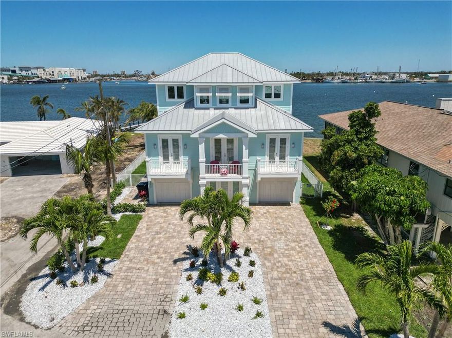 Stunning, 3 Story Bay Front Home with panoramic views of the Back Bay.  Home has been completely restored from Hurricane Ian, including  14x28  heated pool and 6 person Spa. Located in the weekly rental district and just a short walk to the Beach and Downtown Entertainment Area. House is beautifully decorated and all furnishings and accessories, linens, kitchen supplies are included.  Interior Features  include  Elevator with window for Gulf view and automatic doors, gas fireplace,  stainless appliances, quartz countertops,   security system and surround a sound wiring.  Huge Master Bedroom with private balcony and bath with soaking tub.  Three additional guest bedrooms with private baths.  Huge great room, kitchen and dining area overlooking the Bay.  Gas Fireplace and  wine  bar for entertaining your Guests. It  features a huge Bay Front lanai  to enjoy  views of the Shrimp Fleets, Bridge and expansive Bay.  Two car garage with huge lower storage are and patio with Outdoor Kitchen with built in gas grille and granite countertops.  All patio furniture is included. 
Boaters Paradise, 80 ft. long dock with 20,000 lb lift with 4 Motors.  Photos Are Current Property Condition.