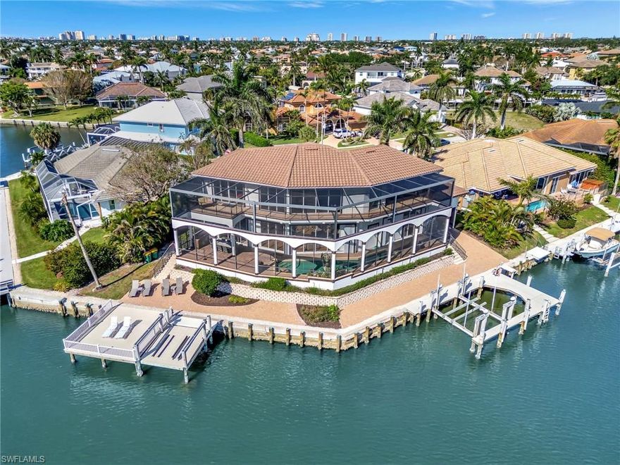 THIS REMARKABLE 4 BEDROOM PLUS DEN LUXURY HOME WITH ITS IMPRESSIVE 162 FT OF SEAWALL AND ASTOUNDING BACKYARD BOATING, DINING AND RECREATIONAL PARADISE DELIVERS IMPRESSIVE WIDE WATER VIEWS FROM EVERY ROOM.  Custom-built home on an oversized lot with deep water QUICK DIRECT access can accommodate larger vessels and no bridges. Perfectly located, this home sits on an ELEVATED,BEAUTIFUL and QUIET cul-de-sac lot in a coveted section of Marco Island. A grand great room features soaring ceilings and lots of natural light. The elegantly designed modern interior is ready for immediate enjoyment or a seamless investment opportunity. The updated kitchen is thoughtfully designed for entertaining, featuring modern appliances and plenty of seating. This custom home was professionally decorated to comfortably house the ENTIRE family together under one roof.  Come build lasting memories watching the dolphins and manatees frolic right from your docks. Recent upgrades include a newer tile roof (2019), new AC system (2022), and new hot water heater (2022), Screen enclosure (2019)—ensuring comfort and efficiency for years to come. Step outside into your private tropical oasis, where a sparkling pool awaits with an electric heater, a tranquil Tres-Serenas waterfall statue, and a 4 PLUS car garage. Enjoy your morning coffee or evening cocktail with a breathtaking view of intersecting canals, offering both serenity and beauty. The eastern rear exposure provides sun-drenched mornings and cool, shaded afternoons. Boaters will appreciate the private dock for large vessels as well as a double jet ski lift. Fish all day out in the 10,000 islands or right at your dock and clean your catch at the fish cleaning station. Then take your catch to one of the many restaurants on the island where they will cook it up for you. Located just minutes from Marco Island’s pristine beaches, upscale dining, and boutique shopping, this home is the perfect blend of lifestyle, location, and long-term value.