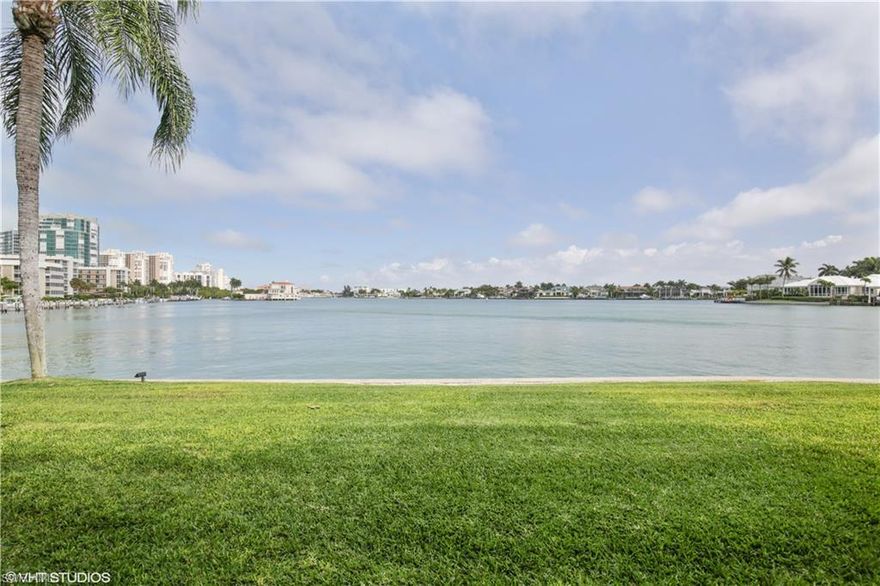 Rarely available three bedroom home with spectacular, panoramic views of Venetian Bay.  Enjoy watching the boats go by and the dolphins frolicking right in front of you!  Feels like a single family home with great privacy, located on first floor, it’s an end unit with only 4 units in the building.  Light and bright unit with built-ins, updated kitchen (with 2 wine coolers) and baths.  Enjoy impact resistant windows, inside utility room, 2 walk-in closets in master with built-ins, plantation shutters throughout, hurricane shutters, an outside patio area as well as covered parking with storage.  Harborside Gardens offers beautifully maintained grounds, boat docks for lease, a boat pavilion, heated pool and club room.  The beach access is within walking distance across Gulf Shore Blvd.  Shopping and dining are close by in Venetian Village.  This is truly a spectacular coastal home in a private setting with bay views that cannot be beat!
