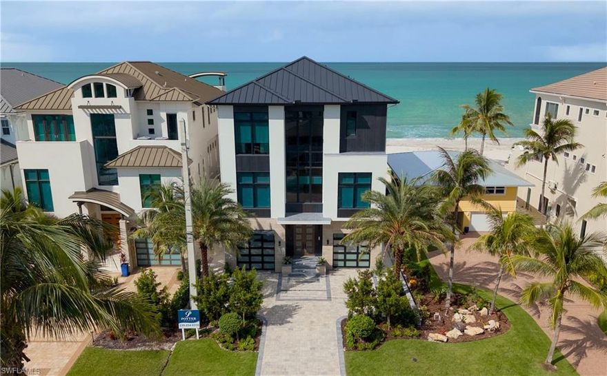 Refined meets relaxed to create the perfect beachfront respite for you and your family. Currently under construction, this Bonita Beach home is brought to you by an award-winning team: built by Potter Homes and interior design by Adelyn Charles; the home will be delivered with the most discerning buyer in mind. The ascent to the main living level reveals an expansive great room with panoramic views of the beach and gulf beyond. This space was designed with entertainment and relaxation in mind. The kitchen features an oversized center island with a state-of-the-art Thermador appliance package. Through the pocketed sliding glass doors is an outdoor living area where countless memories will be made, featuring an infinity edge heated pool with hot tub, outdoor kitchen and pool bath, gas fireplace, and finely appointed outdoor living area. The primary suite will become your private oasis; imagine being soothed to sleep by the soft sound of waves after a long day. This home features the latest smart home technology and is built to weather the storm. The home is centrally located to RSW and the Naples Airport; fine dining, shopping, and golf are minutes away. Expected delivery: Aug 2025.