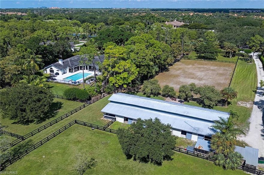 Exceptional five-acre equestrian estate in sought-after Livingston Woods on prestigious Daniels Road. Stunning remodel with an open floor plan centered around a resort-style saltwater pool and expansive outdoor living. Features include soaring ceilings, gourmet kitchen with Thermador appliances, six-burner gas cooktop, built-in coffee station, quartz counters, steam shower in the primary bath, electric fireplace, impact windows and abundant storage. Fully fenced and irrigated with gated entries to the residence and stables. The 10-stall center aisle barn offers two wash stalls, tack and feed rooms, plus two storage bays. Six fenced pastures and a 100-by-200-foot riding arena. Other features include a pristine three-car garage with built-in storage and epoxy flooring, whole-house reverse osmosis, generator, dual well, and mature landscaping. A rare equestrian retreat combining luxury, privacy and convenience just minutes from the heart of Naples and proximity to public schools, Community School and First Baptist Academy.