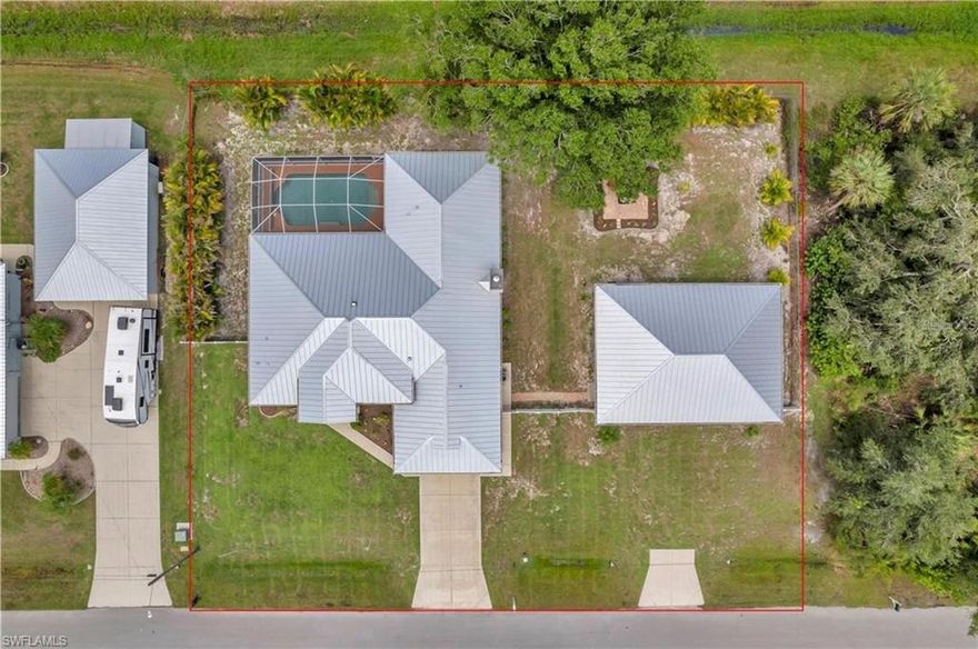 Welcome to your Florida retreat! Tucked away on an oversized lot with mature tropical landscaping in sunny North Port, this spacious 4 bedroom, 2 bathroom pool home offers that relaxed, coastal lifestyle you’ve been dreaming of. From the moment you open the door, you’re welcomed by tall ceilings, tons of natural light, and an immediate view of the heated pool — the kind of first impression that makes every day feel like a getaway. With over 2,300 square feet of clean-kept living space, this home was designed for comfort, functionality, and good vibes. The kitchen has been fully remodeled and shines with upgraded granite countertops & stainless steel appliances,— perfect for everything from quick breakfasts to weekend hosting. Porcelain tile flows throughout the home, keeping things cool, low-maintenance, and cohesive. The primary suite is a total retreat, complete with custom walk-in closets and a recently remodeled walk-in shower that gives off spa energy. Two additional bedrooms provide space for guests or family, while the dedicated office offers a quiet, tucked-away spot for working from home, creative projects, or just closing the door and having some “you time.” Step out back, and your Florida lifestyle kicks into full gear — the heated pool is the centerpiece of a backyard built for both relaxing and entertaining. Surrounded by lush, mature landscaping, a paver deck fire pit area, and a fully fenced yard, there’s room for the whole family, pets, hammocks, and good times under the stars. Saving the best for last - for those who need space to tinker, create, or store all the toys — the detached, air-conditioned 4-car garage with impact-resistant doors checks all the boxes. Whether it’s your workshop, gym, or weekend escape space, it’s ready to go. And yes — it gets even better: This home is not in a flood zone — so no flood insurance required There’s no HOA and no CDD — enjoy your space and your freedom The split floor plan offers privacy and flow The home has been meticulously maintained, and you can feel the pride of ownership in every detail Just a short drive to shopping, dining, nature trails, golf, and the Gulf Coast’s best beaches Whether you're lounging by the pool, working in your home office, or relaxing around the fire pit at sunset, this home offers the perfect blend of chill, charm, and space to truly live. Come experience what easy Florida living really feels like.