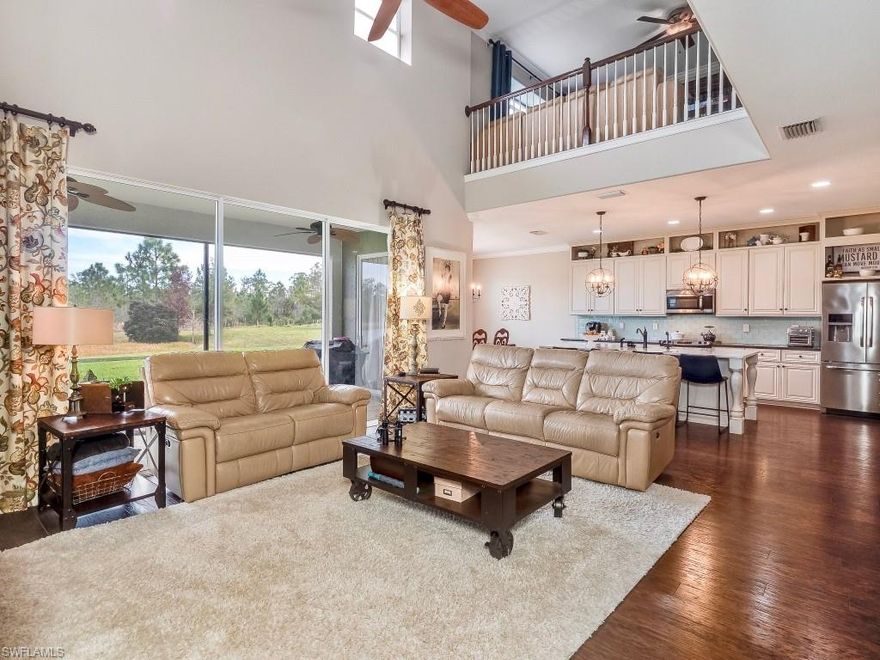 STUNNING! See the pride in ownership in this elegant 5 bed+loft/4.5 bath home that will delight your senses. The moment you step through the front door a sense of space and luxury leads you to an inviting, open-concept that is sure to impress. Entertaining? The bright kitchen boasts an extended island drawing friends & family to gather in the great room or open the slider wall for an outdoor area awaiting your design. High end window coverings and shutters, neutral walls and plank floors throughout the spacious living area lead to split bedrooms ensuring privacy, perfect for a growing family or plenty of visiting guests.  Second story loft with work area perfect for a home office or school space for the kids.  This premium lot offers plenty of privacy and a gorgeous lake view and preserve setting with plenty of room for a pool. Bella Terra has a Resort-style Clubhouse and pool/spa, 24 hour fitness center, activities for all ages, shaded children's play area, tennis courts, pickle ball, bocce ball, sand volleyball, soccer/softball/hockey/football fields, tranquil butterfly garden, walking trails and much more....and the best part is the LOW HOA fees you get in beautiful Bella Terra!