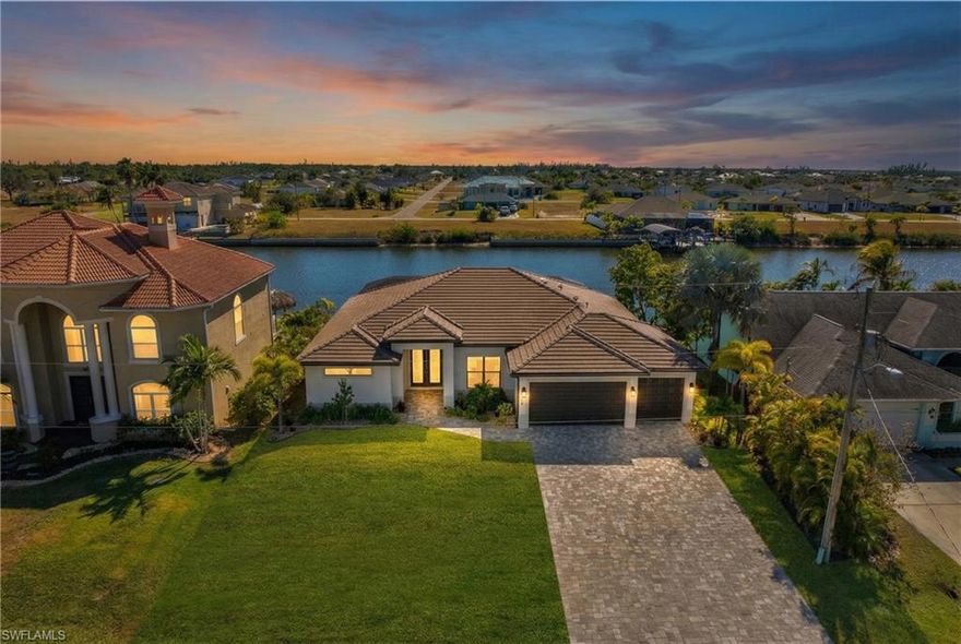 Welcome to 4114 NW 33rd Lane—a coastal retreat showcasing a tile roof, 3 bedrooms plus a versatile den, 2 bathrooms, and an expansive 3-car garage. Set along a 260-foot-wide canal with direct, bridge-free access to the Gulf, this home offers an extraordinary waterfront lifestyle. Step inside to discover an open-concept design enhanced by upgraded large-format tile flooring and abundant natural light. The gourmet kitchen is a culinary enthusiast’s dream, boasting rich espresso cabinetry, upgraded countertops, a wine bar, and a smart refrigerator. A spacious island seamlessly transitions to the living and dining areas, making entertaining effortless. Three sets of sliding glass doors connect indoor living to the oversized extended pool lanai, where you’ll find a custom outdoor kitchen, picture screens, a spa, and a sparkling pool—all perfect for soaking up the Florida sunshine in privacy and style. The master suite is a tranquil haven, featuring two walk-in closets, dual sinks, and an oversized walk-in shower. With its wide canal frontage, no-bridges Gulf access, and prime location near shopping, dining, and recreation, this home is ideal for both personal enjoyment and vacation rental investment. Experience the best of Cape Coral living in this move-in-ready waterfront gem—your Florida dream awaits!