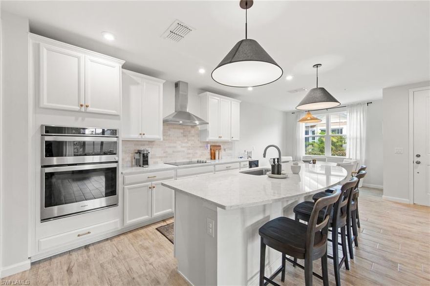 Welcome to this beautifully maintained first-floor, end-unit residence offering modern upgrades, abundant natural light, and an unbeatable Naples location. The spacious Great Room features expansive hurricane-impact sliding glass doors, creating a bright and airy space ideal for relaxing or entertaining. The modern kitchen shines with quartz countertops and sleek contemporary cabinetry, while the screened, covered lanai provides the perfect spot to enjoy Florida living year-round. Additional highlights include an Ecobee smart thermostat and an attached 2-car garage with an epoxy-coated floor. Located in a gated community with resort-style amenities including a pool, hot tub, fitness center, fire pit, and dog park. Just 1.5 miles from the marina and less than 4 miles from downtown 5th Avenue’s dining and shopping. Outside of a flood zone—no flood insurance required. Schedule your showing today!