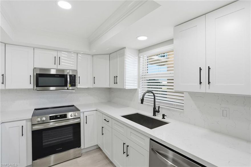 Welcome to this renovated FIRST-FLOOR CONDO, offering two bedrooms and two baths with a fresh, COASTAL INSPIRED DESIGN that feels both modern and welcoming. THOUGHTFULLY UPDATED from top to bottom, this residence is ideal for comfortable year-round living or as a refined seasonal retreat.  The interior showcases LUXURY VINYL FLOORING throughout - complemented by new RAISED-PANEL INTERIOR DOORS, modern hardware, and 5-inch base trim for a clean, finished look. The kitchen offers NEW SELF-CLOSING WHITE CABINETRY, SLEEK QUARTZ COUNTERTOPS extended as a full-height backsplash, BRAND NEW SS APPLIANCES, and CUSTOM LIGHTING with trayed ceiling that enhances both style and functionality. Both bathrooms feature coordinated coastal-inspired updates.  Additional improvements include NEW WINDOWS and a NEW SLIDING GLASS DOOR, providing  natural light, along with a newer water heater for added peace of mind. The first-floor location offers easy access and everyday convenience.  Ideally situated in Naples, this condo is just a FEW MINUTE DRIVE TO GULF BEACHES, 5th Avenue South shopping and dining, and all that Southwest Florida has to offer. Marco Island is also nearby, providing easy access to fishing, boating, and renowned shelling beaches.  With its prime location, and low-maintenance lifestyle, this condo presents an excellent opportunity to enjoy the Naples lifestyle to its fullest.  55+ Community.   Buyer to verify all information.