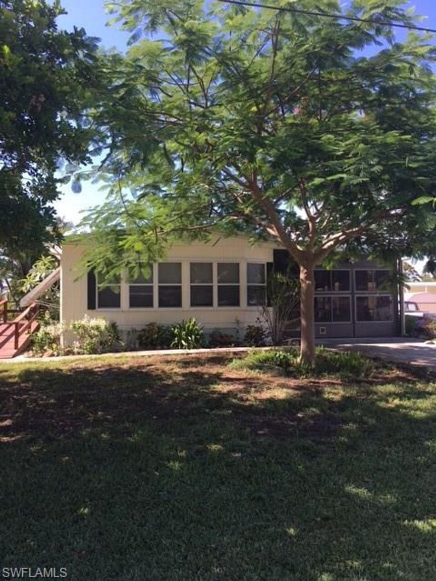 Why not live in Paradise full time or during our beautiful Paradise winters.   This maintained manufactured home is only minutes away from some of the best fishing in the area.  This home comes with a 10' easement to your new covered boat lift and dock.   Plenty of storage with an outside shed and a workshop in the laundry room.   It also has a 4 season sunroom for those beautiful Florida sunrise and sunsets.