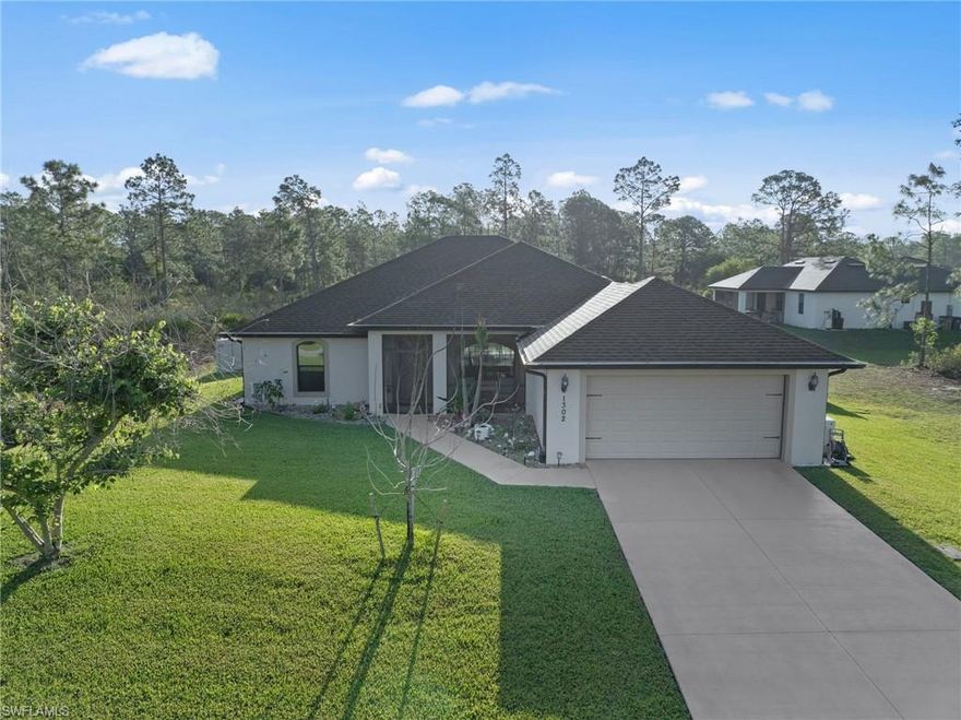 FOUR BEDROOM TWO BATH POOL HOME BUILT IN 2019! Over 2000 square feet of living area in this like new home on a cleared and beautifully landscaped half acre lot surrounded by a PRIVACY FENCE, 16 X 10 storage shed, AUTOMATIC 22 KW GENERAC WHOLE HOUSE GENERATOR with 500 gallon propane tank buried under ground, SHINY PORCELAIN TILE FLOORS THROUGHOUT, cathedral ceilings, large great room, GRANITE TOPS IN THE KITCHEN AND BATHS, tile backsplash in the kitchen with soft close doors and drawers and crown molding on the cabinets, pantry and breakfast bar with stone tile accents under the breakfast bar, stainless steel appliances, primary bedroom with tray ceilings, access to the pool area, walk in closet and private ensuite bathroom with dual sinks, large vanity, separate water closet, large walk in shower with wood tile accents and multi head shower, spacious guest bedrooms one with a walk in closet, indoor laundry room with plenty of cabinet space, granite top on the laundry sink, new inground pool and spa installed in January 2021 with spa integrated into the pool, solar and electric heat, travertine tile on the pool deck for easy maintenance, specialty screening surrounds the pool enclosure giving it a rainforest atmosphere and plenty of privacy, you can see out but they can't see in, covered patio area plus plenty of deck space around the pool, perfect for entertaining, night lighting around the pool is noted in the pictures, pool bath access, excellent neighborhood atmosphere with larger estate sized homes, excellent location just minutes to I-75, Ft Myers and the SWFL International Airport,  NO FLOOD INSURANCE REQUIRED. LEHIGH IS THE HIGHEST ELEVATION IN LEE COUNTY.