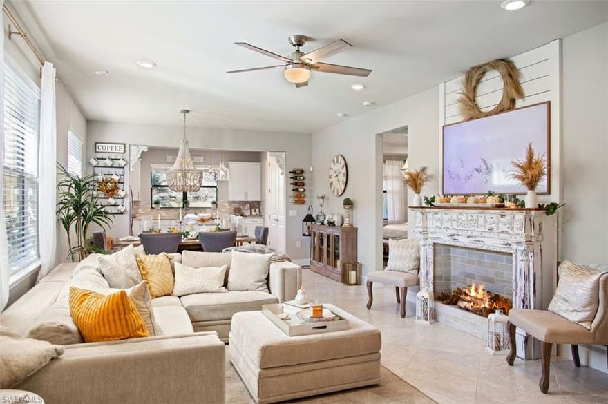 YOU WILL FALL IN LOVE THE MOMENT YOU STEP INSIDE! Resort Style Community Of CORKSCREW SHORES! Light, bright & airy best describes this OPEN FLOOR PLAN with cool hues  & plenty of windows welcoming the sunshine. 2 Bedrooms, offce/den & 2 full baths. Easy living affordably priced $400k's. Situated off the kitchen you'll fnd an extended, screened lanai with tranquil tropical palms, no neighbors behind. Covered front porch with unique archways. Upgraded kitchen features a huge island, pantry, white cabinets, glass tile backsplash and glistening quartz countertops. Gorgeous tile fooring, tray ceilings, 8 ft doors. Extended garage with sink. IMPACT hurricane windows. Beautiful owner's ensuite featuring dual sinks and a large walk-in closet with custom cabinetry. Room for a pool if desired or just around the corner from the community pool and amenities. Corkscrew Shores has everything you're looking for in a highly desirable area of Estero, close Hertz Arena, FGCU, RSW Airport, Beaches, restaurants & shopping. Pristine 240 acre lake surrounds 'Amenity Island' resort style pool, fishing pier, kayak launch, restaurant, bar, fitness center, sunset firepit, playground, pickleball, bocce ball, tennis courts, sidewalks & dog friendly community. Fire is simulated. Ornamental fireplace does not convey.