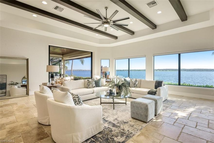 AVAILABLE NOW! This "casual lakefront luxury" 3+Den, 3.5 Bath CUSTOM Arthur Rutenberg built home offers an open floorplan with two sets of 10' of pocketing sliding glass doors to the lanai & multiple picture windows overlooking the 250 acre "Stone Lake". Oversized 4 CAR GARAGE with the potential to add 4 car lifts for a total of 8 cars. A long list of special features include: travertine tile floors throughout the common areas; HURRICANE IMPACT WINDOWS/DOORS; Electric roll down shutters on the lanai; murphy bed in den; whole house water softener; GAS heated oversized spa; rich moldings, beams, & ceiling details; GE Monogram appliances; AC Garage; & more! The Quarry is a lakefront community offering something for everyone: Boating, Golf, Tennis, Pickleball, Bocce Ball, Tiki Bar, Restaurant, Pool-Side Food/Drink Service, Gym, Social Activities including Full Time Social Director, and more! The Quarry offers a lifestyle like no other, including an impressive "Lake Lodge" and over 500 acres of navigable lakes and a private 18 hole Golf Club (Not Mandatory). An impressive $18M renovation & expansion of the Lake Lodge & Beach Club to be completed 2023. Total HOA/Club fees only $6972/yr!