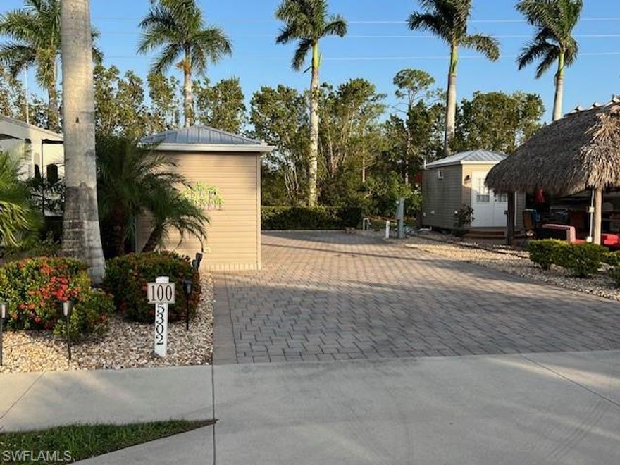 Lot 100 offers you a complete paved lot with very nice neutral colors that is facing west and in this area of the park it has some of the most available privacy.   It is just steps away from the doggy park and the recycling center on Cypress Trail resort Circle.  There are no RV lots behind you only a nice fence to separate you from the storage area.  Included on the lot is an Amazon 8 x 14‘ finished shed that includes a extended 8 x 15‘ roof to create a porch that offers you additional sun / weather protection.  The extended roof includes a fan and is maintenance free.   A large paved two step entrance going into your shed has been added for additional safety when you step inside your professionally finished shed.  The shed is complete with drywall and insulated LED lighting Soft blue paint.  Also included in the shed is a one piece fiberglass shower, toilet, sink/vanity with drawers and a large floor to ceiling wall cabinet for additional storage.  There is an on-demand hot water heater and a mini split that will keep you comfortable along with your ceiling fan year round.   Small stones trim out your side and backyards and there is some nice landscaping on this property.