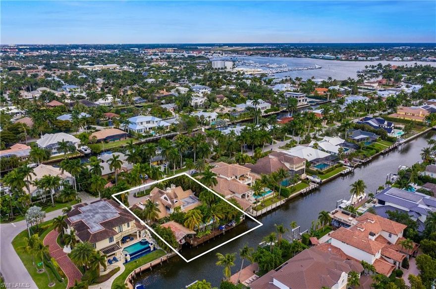Spectacular.  Move right into this home located on a fabulous lot in Aqualane Shores. Character abounds  in this two story pool home with great covered boat house . If you prefer, take this opportunity to build a custom Estate home .Included in these photos is an example of a new home design by  Jon Kukk ,the renowned architect located here in Naples ,Florida . Work directly with Jon to put all your wishes into this or any design of your choice on this waterfront lot in Aqualane Shores. Diamond Custom homes is happy to work with your buyer or please feel free to chose designers and builders of your choice. 
 Southern facing pool with boat house and lift, separate lifts for jet skis with boat dock extra large pool area and guest suite