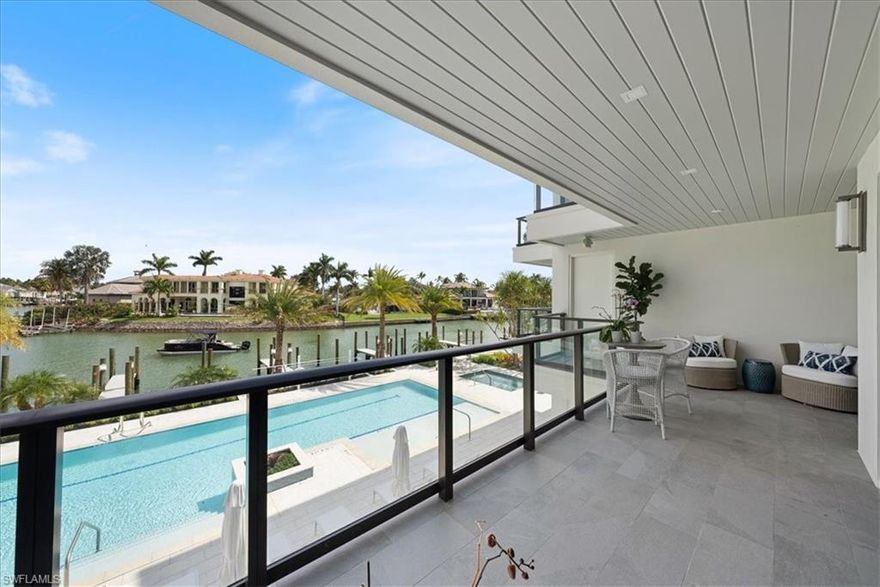 New Construction and MOVE IN READY! This home has been meticulously designed and furnished with all of the high end design elements you would expect with new construction on the Bay in the Moorings. La Perle is the only finished new construction building on Gulf Shore Blvd where the amenities and interior of this unit will not disappoint. Custom crafted with Legno Bastone Engineered white oak hardwood throughout this over 3,000 sq ft home with a split floor plan allowing separation between primary and guest suites with gorgeous views from every room. This home boasts a wide open floor plan with ample dining, great room with natural light flowing in from the covered balcony overlooking the bay and a large chef's kitchen. Subzero Fridge, 48" Wolf gas Range, Wolf microwave drawer, fridge drawers, a large island with double waterfall edges, and an additional wet bar with wine fridge. This unit has 3 en suites plus 2 dens. As you step off your secured elevator that opens into your private lobby you have a large den that could also be used as a media room. The second den/flex space is off the private balcony of one of your 2 guest suites.  You will have a hard time deciding between spending time in your beautiful unit or enjoying the Naples Lifestyle right outside your door. Your large covered balcony overlooks Naples most beautiful sunsets while you watch dolphins, boats, and birds all day long. Walk up the stairs from your balcony to the rooftop deck for entertaining or catching some sun all day. Besides the rooftop deck, the amenities include an oversized lap style resort pool with seating, large spa, putting green, fire pit, and docks for lease or purchase when available. Steps to the new Four Seasons under construction, just North of 5th Ave and 3rd St dining and restaurants, just South of Venetian Village, Waterside Shops, and easy access to the Moorings Private Beach club if you want to join! This location, new construction, views of the Bay and steps to the Beach, it really doesn't get better than this!