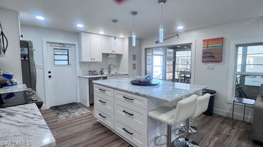 Experience luxury living in this beautifully remodeled manufactured home featuring 2 bedrooms, 2 bathrooms, and modern flair throughout. Step inside to discover a spacious open-concept layout adorned with elegant vinyl flooring and stainless steel appliances in a sleek, updated kitchen. The granite countertops and large island with seating for six provide the perfect setting for entertaining guests or enjoying cozy meals at home.
Each bathroom offers refined comfort, including a tub-shower combo and a walk-in shower for your convenience. Completely remodeled in 2025, including new windows, this home perfectly blends style and functionality with every modern detail thoughtfully selected.  Outside, take advantage of community amenities like the heated saltwater pool, where you can relax and soak up the Florida sunshine—making every day feel like a vacation.
This turnkey home is ready for you to move right in and start embracing the luxurious, carefree lifestyle you’ve been dreaming of. Don’t miss your chance to own a true piece of paradise in Old Bridge Village Co-op!
Old Bridge Village, is a friendly, 55+ resident owned community right off the Caloosahatchee River and Gulf Access with lots of amenities, activities all year, clubs and entertainment.  There is a resort style brand new Salt-water  heated pool and hot tub, fitness center, recreation center, bocce ball, pickleball, shuffleboard, tennis, basketball, putting green, horseshoe pits, community clubhouse, fishing pier, kayak and boat launch and an 81 slip marina.   Drive your golf cart around the community, to and from your activities or to Palm Point where you can fish, have a picnic, watch the boats or just enjoy the sunset.  This community is a hidden gem with just minutes by boat or car to downtown Ft. Myers and right between 2 airports with approximately 30 minutes to both Southwest Florida International Airport and Punta Gorda Airport.