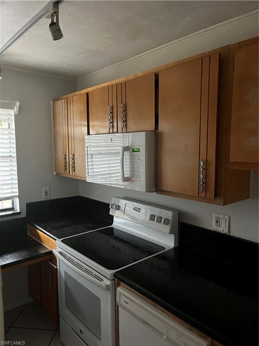 Welcome to Woodgate  condo conveniently located between Downtown Naples and Marco Island that rarely becomes available. This spacious 2-bedroom, 2-bath residence delivers the kind of elevated design, effortless livability, and prime location that buyers wait years to find. From the moment you step inside, the home feels refined yet welcoming. Light and airy palette from the kitchen  featuring  cabinetry, solid appliances, nice countertops perfect for everyday living or entertaining with ease. The open-concept layout flows seamlessly through the dining and living spaces, creating a natural rhythm for gatherings or quiet evenings at home. Both bedrooms are generously sized and designed as serene retreats. The primary suite offers a peaceful escape with  en-suite bath while the guest suite provides comfort and privacy for visitors. Step outside to the screened-in patio, where mature trees provide exceptional privacy, shade, and a tranquil setting—your own secluded oasis for morning coffee or unwinding after a day at the beach. Located in the charming Woodgate community, this residence offers a quiet, neighborhood feel while being just minutes from downtown Naples, world-class beaches, shopping, dining, and entertainment.