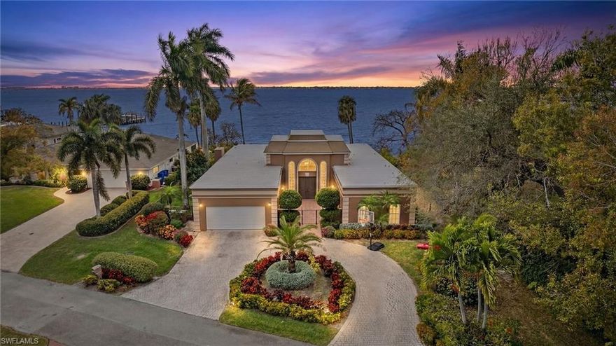Warm tropical breezes drift across the wide, shimmering expanse of the Caloosahatchee River, setting the tone for life at this exceptional waterfront residence. Designed to capture breathtaking panoramic views, the home embraces its setting at every turn, inviting the outdoors in and creating an atmosphere of effortless elegance and serenity. Nestled along a private street in one of Fort Myers’ captivating riverfront neighborhoods, just moments from the historic Edison and Ford Winter Estates and the vibrant energy of downtown, this residence offers a rare blend of tranquility and convenience. Boutique shops, acclaimed restaurants, and lively community events are only a short distance away, yet the home itself feels like a secluded retreat. A circular drive and gated courtyard entry framed by lush tropical landscaping creates a graceful arrival. Inside, double doors open to a grand foyer with soaring ceilings and refined architectural details, while captivating river views form an immediate and unforgettable first impression. From this moment forward, the water becomes a constant companion, visible, soothing, and ever-changing. At the heart of the home, a stunning chef’s kitchen blends beauty and function, featuring rich brickwork, stainless steel appliances, and generous preparation space. Sweeping river vistas elevate everyday moments, and the kitchen flows seamlessly into the main living areas, where a wall of glass frames endless water views and fills the home with natural light. The spacious yet inviting living room offers a relaxing sanctuary, with boats and native wildlife creating a living work of art beyond the windows. Designed for both entertaining and everyday comfort, the floor plan includes elegant indoor dining and a beautiful outdoor dining area ideal for enjoying Southwest Florida’s year-round sunshine and waterfront breezes. The split floor plan ensures privacy, highlighted by an expansive primary suite featuring a private fitness space and a spa-inspired bath. Additional guest suites are generously sized, and a dedicated media room provides the perfect setting for movie nights or watching the big game. Enhancing the appeal even further, the home is now offered fully furnished, an exceptional opportunity for immediate enjoyment. Thoughtfully curated pieces complement the architecture and waterfront setting, allowing you to move in effortlessly and begin living the riverfront lifestyle from day one. Outdoor living unfolds across an expansive covered lanai overlooking the sparkling pool and sweeping backyard (replete with mature mango, star fruit, lemon and orange trees) that stretches to the river’s edge. This serene setting invites sunset gatherings, outdoor recreation, or quiet reflection, offering endless possibilities framed by the calming rhythm of the water. This is more than a home, it is an invitation to slow down, breathe deeply, and embrace the timeless beauty of true riverfront living.