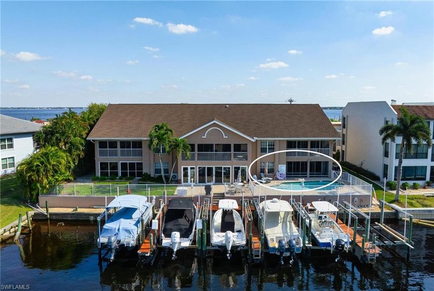 ATTENTION BOATERS! DEEDED 10,000 LB LIFT! DIRECT ACCESS! Both Eastern and Western views! In this rarely available River View 1st floor condo this can be your reality! This three-bedroom two bath unit, on a serene Cape Coral canal is ready for you whether it is your permanent residence or your winter getaway! The split floor plan offers privacy-primary en-suite secluded with the other two bedrooms sharing an updated bath! The kitchen, with both a dinette area and breakfast bar, is bright and functional for entertaining. The open living and dining rooms blend indoor-outdoor vibes with canal and pool views from every angle. Step into your spacious screened lanai, with electric hurricane shutters, and walk directly out to the pool. Best access and view in the complex! This unit comes with an in-unit laundry closet, a one car garage with utility side entry as well as a deeded 10,000 lb. boat lift. The electronic lift sits in the 12Wx30L dock and has both water and electric. No bridges so you have direct access to the River and can take the intracoastal South to the Gulf of Mexico or North to N. Ft. Myers! This six-unit complex is well cared for and well managed. Located at the end of Beach Parkway, there is no thru traffic and sidewalks are available for walking or biking. Amazing proximity to the new Jaycee Park which will include a Riverwalk as well as numerous activities for both children and adults. Located near shopping, specialty stores and restaurants, all you will need is within a short distance!