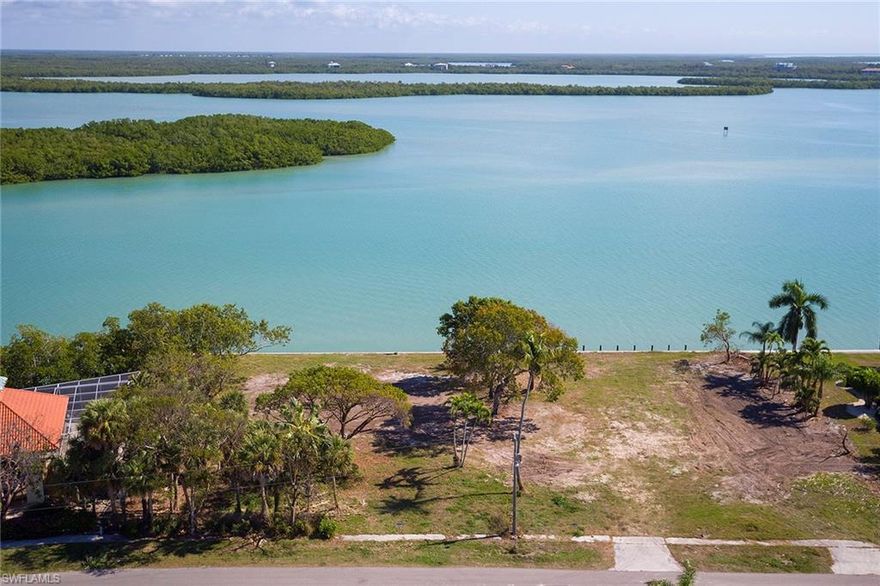 Beautiful, half-acre, direct access lot on Barfield Bay in the prestigious Estate-section of Marco Island. Enjoy serene, panoramic views of the bay, area Islands, colorful sunrises, abundant birds and marine wildlife. The lot adjoining this site is also available (Blk. 403, Lot 20 $1,950,000) which would give someone an extremely unique situation and incredible building opportunity to have a double-lot in the Estates on Marco Island. The lot is cleared and ready to go. In January 2017, this property was separated from 945 Caxambas.