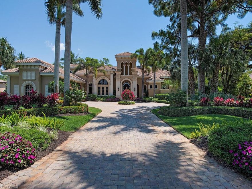 Enter this breathtaking two-story estate via the custom paver drive surrounded by lush tropical landscaping. Gorgeous views of the 15th fairway surround this magnificent estate, spilling into the home through abundant windows. Soaring tray ceilings and expansive seamless windows punctuate the elegant formal living room. The spacious open kitchen features custom cabinetry, top of the line built in appliances and a large center island. Enjoy cocktails from the full-service wet bar while hosting guests in the formal dining room. Wood coffered ceilings add warmth to the family room with 90 degree disappearing sliders allowing tropical views to flood the space. The home office features brilliant wood flooring & handsome built ins. Abundant natural light fills the  master suite through tall windows & French doors leading to the outdoor retreat. A second story loft is the ideal space for hosting guests with two spacious bedrooms & a delightful terrace overlooking the golf course. Rich wood ceilings highlight the loggia covering the summer kitchen, outdoor fireplace and endless outdoor dining and lounging spaces. Beautiful palm trees punctuate the expansive sparkling pool & spillover spa.