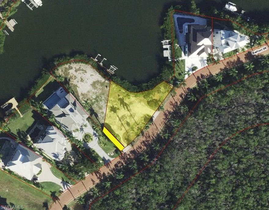 This large bayfront lot (PID# 23095002951) is located in the double gated Bayfront Gardens and within the beautiful community of Barefoot Beach. This lot features 158’ of waterfront, is the ultimate location to build your 3 or 4 story luxury waterfront home and will provide wide water views plus there are no homes across the street - just a beautiful nature preserve.  The lot is 13,866 SQ FT (.318 acres) and has all utilities at the lot. You will be able to design your custom boat dock with lift and jet ski lift that will provide a short ride to the Gulf of Mexico with no bridges. And best of all - it is just a short walk to the white sandy beaches of Barefoot Beach via one of two private beach accesses for use by Bayfront Gardens residents. The previous home was removed and will result in no impact fees at permitting - a huge savings. A recent survey is available with all setbacks indicated.  Barefoot Beach is one of Collier Counties most desirable Beach to Bay communities and includes one of the highest ranked beaches in the country, 24 hour guard patrols, manned guard gate, and the option to join the fantastic Club at Barefoot Beach including its full service attendants at the beach and pool, casual and fine dining, a busy event calendar, tennis with pro and more. Put a deposit for a membership when purchasing the lot and the wait list should be over when your house is finished plus you will have limited usage during the wait.