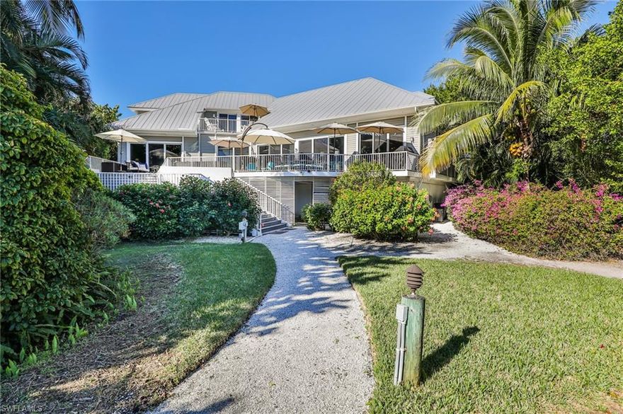 Exquisite Captiva waterfront estate home located on Roosevelt Channel with wide open views. This bay front retreat features elevator, private dock, private heated pool, 10 lb boat lift, kayak lift and deeded beach access. Lush tropical vegetation on over 1 acre that will allow for a second structure/second home. "Hakuna Matata" is an established vacation rental home like no other or would make the perfect second home. Flexible renal program offering unlimited owner use along with a short term vacation rental home. Offering fully furnished, turn key with exceptions. Additional features include upgraded glass, three car garage along with two master suites, office, morning kitchen. Escape to paradise and live like a local! More photos coming soon...