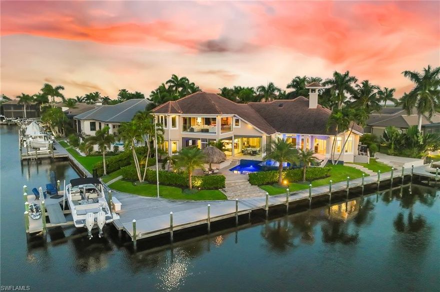 Set within what many consider Cape Coral’s premier waterfront neighborhood, this extraordinary estate in The Estates of Cape Harbour delivers a lifestyle centered around luxury outdoor living, yachting, and entertainment. Positioned at the intersection of the deep-water South Spreader Waterway and the Deep Canal, the property captures sweeping long-water views and offers direct Gulf access with dockage suitable for a yacht up to 100 feet. The waterfront experience is exceptional, featuring approximately 220 feet of water frontage, composite decking, an expansive Captain’s Walk dock, and a premium lift system designed for effortless boating.
Equally impressive is the home’s resort-style outdoor retreat and entertainment amenities. The newly resurfaced heated tiered saltwater pool and spa overlook the water, creating a spectacular setting for relaxing or entertaining alongside the covered loggia and fully equipped summer kitchen. Inside, a state-of-the-art private movie theater delivers an immersive cinematic experience, while the upstairs game room with full bar and balcony access further enhances the home’s luxury resort atmosphere. Beautifully furnished and thoughtfully renovated throughout, this is a rare waterfront estate designed for elevated coastal living.