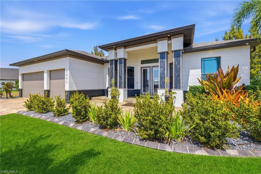 ***NO FLOOD INSURANCE REQUIRED*** Welcome to 2003 SW 29th Terrace—an exceptional Gulf access residence where luxury design meets true Florida waterfront living. The Osprey Grande by Coral Isle Builders is a multiple award-winning home in SW Fl. This mode won 2016 CCCIA Builders Showcase award for Best Livability Overall in its's category with accolades for Best Exterior Design, Interior Design and Pool. The Home also won 2019 CCCIA Builder's Showcase Award. From the moment you arrive, the striking modern elevation, lush tropical professional landscaping with curbing and black canyon rock and LED lighting, and expansive 3-car garage set the tone for what’s inside. The home has been freshly painted on the exterior and the driveway and porch pavers were cleaned, sanded and sealed in 2025. This meticulously maintained 3-bedroom with office/den, 3-bath home offers a seamless blend of sophistication and comfort with an open-concept layout, soaring coffered and tray ceilings, and oversized sliding glass doors that completely disappear—creating a flawless indoor-outdoor living experience. Spray For energy efficiency, all living areas have spray foam insulation. The heart of the home is a stunning chef’s kitchen featuring an oversized 16 Ft waterfall-style granite island, rich custom cabinetry with soft close, stainless-steel appliances, and a built-in wine bar—perfect for entertaining. The space flows effortlessly into the main living area, all overlooking the pool and canal. Step outside to your private resort-style lanai with Travertine flooring that was cleaned, sanded and sealed in 2025, designed for year-round enjoyment. The custom pool is truly a showpiece, complete with a sun shelf, in-water seating, elevated spa, and tranquil water features. The expansive covered outdoor living area features a Southern Pine (Synergy Wood) ceiling, built-in fireplace, and a fully equipped outdoor kitchen—ideal for hosting or relaxing in style. Boating enthusiasts will appreciate the beautifully finished composite dock equipped with water, electric and lights and a 27 ft boat slip with covered 10,000 Lbs. lift plus a kayak launch, offering Gulf access and quick open water convenience. Enjoy peaceful canal views, tropical landscaping, and plenty of space to unwind or entertain right at the water’s edge.  All closets feature wood shelving. The primary suite bathroom offers a spa-like retreat with dual vanities, custom cabinetry, and an oversized walk-in shower with premium tile finishes. Guest bathrooms are equally well-appointed, continuing the home’s high-end design throughout. Located in a highly desirable SW Cape Coral neighborhood surrounded by newer luxury homes, this property offers the perfect combination of privacy, elegance, and boating lifestyle. This is more than a home—it’s a statement property designed for those who expect the best of waterfront living. This Home is a Must See!!! Schedule a Tour Today!!!