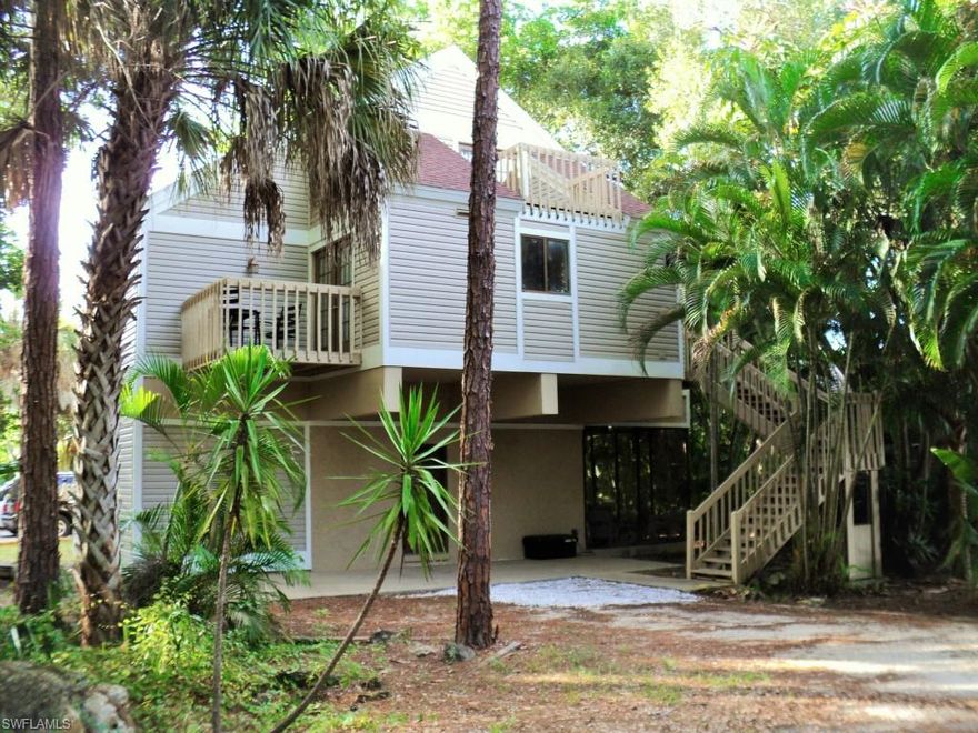 Laurel Oaks gated Community, Logangate Home Timber Treehouse! Live in this truly amazing one of a kind home surrounded by treetops, stone, elevated wood decks, Stone Fireplace, exposed timber lofted ceilings with skylights, sidelights, French doors to let the natural light in this elevated three bedroom home. The private upstairs Master Bedroom has its own private deck overlooking the peaceful landscape and the two bedrooms on the main floor each have French doors leading out to private decks.  At ground level you will find timber ceilings in this playroom for all with two sets of French doors leading out to a large screened in lanai along with another bedroom with separate full bath.  Tile floors and tiled walled bathrooms, granite surfaces in the kitchen with Stainless Steel appliances.  Lush low maintenance natural landscape with new siding 2014 and roof in 2010!  Private Community Amenities include pool, clubhouse with Pool table, Ping Pong, Fitness Room, Outdoor BBQ and tables, Community room, Playground , Lighted tennis and basketball courts.  This home has so much to offer along with its location in Ft. Myers makes this home something rarely seen at this price.