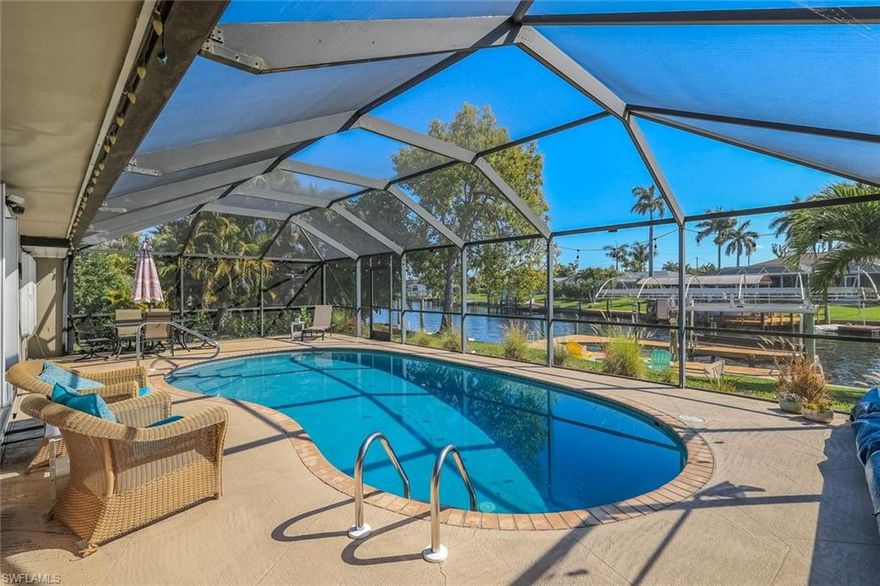 This beautifully maintained turnkey 4-bedroom, 2-bath canal-front pool home offers the perfect blend of comfort, upgrades, and investment potential in a prime Cape Coral location. Situated on the San Carlos Canal—one of the area’s largest mainline canals—this property offers excellent boating access to open water with just one bridge, making it a true boater’s dream. The dock is equipped with electric and water, along with a 7,000 lb boat lift featuring a brand-new canopy.

Ideally positioned in one of Cape Coral’s hottest and most sought-after areas, this location offers the ultimate Southwest Florida lifestyle—where boating, waterfront dining, and sunset cruising are part of everyday life. Spend your days exploring nearby beaches, heading out for fishing adventures, or docking at local restaurants for dinner by the water. With close proximity to shopping, entertainment, and vibrant nightlife, this area continues to attract both full-time residents and visitors alike, making it especially appealing for a vacation rental opportunity.

Designed for effortless Florida living, the home features a light and bright interior with a flowing layout that lives comfortably for both everyday living and entertaining. Step outside to a spacious lanai with an in-ground saltwater pool overlooking the canal, creating a peaceful, private setting that truly captures the essence of a Florida escape.

Recent updates provide peace of mind, including a new roof (2023), pool pump and heater (2023), pool screen enclosure (2022), and AC system (2020). The home is equipped with impact-resistant windows throughout most areas, adding security and efficiency. A 2-car garage offers added convenience and storage.

With a strong vacation rental history, this property presents an exceptional opportunity as a highly desirable vacation rental property, full-time residence, or seasonal retreat.

Importantly, the home has never experienced water intrusion from previous storms—a standout feature that provides exceptional peace of mind. Despite recent hurricane activity in Southwest Florida, this property has remained dry, reinforcing the home’s strength, positioning, and desirability—an invaluable advantage for both homeowners and investors.

Enjoy the ideal combination of waterfront living, modern updates, and relaxed coastal charm—this is truly a place to unwind and enjoy the Florida lifestyle.