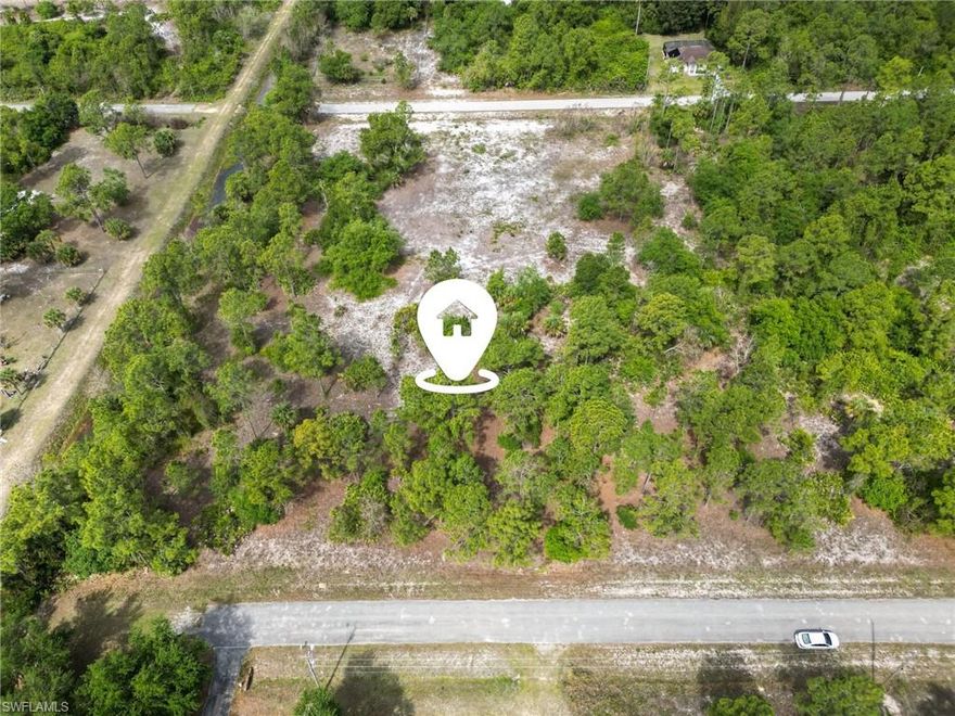 Build your future in the growing community of Lehigh Acres, Florida with this spacious 1/2-acre vacant lot offering the ideal setting for your custom home. With a generous homesite, this property provides plenty of room to design a residence that fits your lifestyle—whether that includes a pool, outdoor entertainment space, detached garage, RV or boat parking, or additional landscaping for privacy and curb appeal. Located in a quiet and developing residential area, this parcel offers a peaceful setting while still maintaining convenient access to everyday essentials. Enjoy easy connectivity to State Road 82, allowing for a straightforward commute to Fort Myers, I-75, Southwest Florida International Airport, and surrounding employment and commercial hubs. Nearby, you’ll find shopping centers, dining options, schools, and healthcare facilities, all within a reasonable drive. For recreation, Southwest Florida’s world-famous beaches, golf courses, nature preserves, and outdoor attractions are just a short drive away, offering year-round enjoyment. Lehigh Acres continues to see steady residential growth and development, making this an attractive opportunity for both future homeowners and investors. Whether you plan to build right away or secure land for future use this is the place to buy! With no HOA, you have the flexibility to create a home that truly fits your needs without unnecessary limitations. Don’t miss your chance to own a sizable residential homesite in one of Southwest Florida’s fastest-growing areas. Bring your vision and start planning your future today.