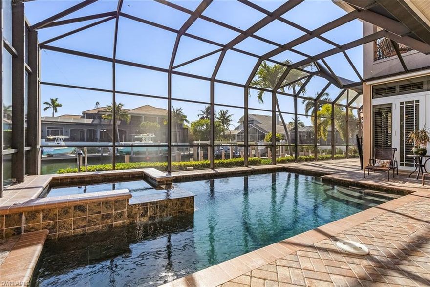 Paradise awaits you at this on the water home in the sought after Tiger Tail Beach area on Marco Island. This home is  located on a quiet cul-de-sac and only 2 blocks from Tiger Tail Beach entrance. This 4 bedroom plus den, 3.5 bath home can easily accommodate 2 families. First floor features the primary suite with a stunning glassed walk-in rain shower and separate tub. Custom gourmet kitchen with island sink & seating and mitered glass breakfast nook. Formal dining room with butler’s pantry, family room, separate office with double French doors, an en-suite guest bedroom. Upstairs are two bedrooms with balcony access, a full bath with double sinks and large media room with service bar making it the perfect guest sanctuary. Outside the spacious screened  lanai boasts a beautiful, heated pool & spa. Large kitchen with built-in grill, sink, refrigerator & customized seating area with access to a full bath. Enjoy the island lifestyle from this ideal location  just minutes to Tiger Tail Beach.